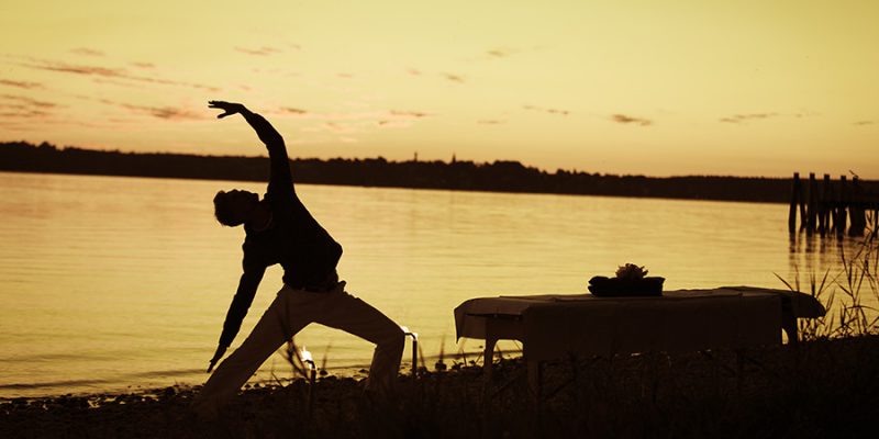 Golden sunset reverse warrior yoga pose